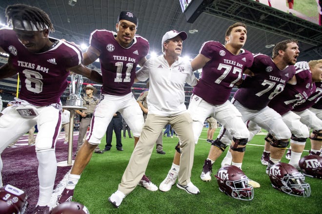 Texas A&M head coach Jimbo Fisher celebrates with his players after defeating Arkansas 24-17 in an NCAA college football game Saturday, Sept. 29, 2018, in Arlington, Texas. (AP Photo/Jeffrey McWhorter)