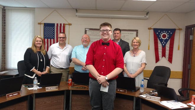 John Glenn High School senior Christian Millison was recognized by the East Muskingum Local Board of Education for receiving the Daybreak Rotary Outstanding Music Award for Orchestra. Also pictured are board members, l to r, Shala Zemba, Mike Mathers, Ken Blood, Matt Abbott, and Gail Requardt.