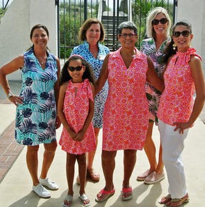 Lexi Carr (from left front), her grandmother Dee Dee Bunnell and Lexi's mom Nicole Carr modeled matching outfits at the First Coast Women's Services annual fashion show at Casa Marina hotel. Board chair Julie Van Voorhis (from left back), Katherine Way of Katherine Way's boutique, and fashion show moderatorStephanie Kearney helped produce the fundraiser that empowers women to make informed choices about pregnancy. [JACKIE ROONEY/FOR SHORELINES]