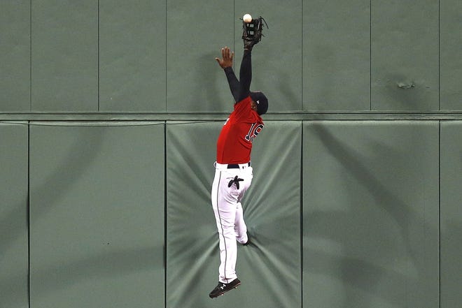 Boston Red Sox's Jackie Bradley Jr. makes the catch in a game earlier in the season. Despite offensive struggles, Bradley Jr.'s defense has been crucial toward the ballclubs success this year. [AP File Photo/Michael Dwyer]