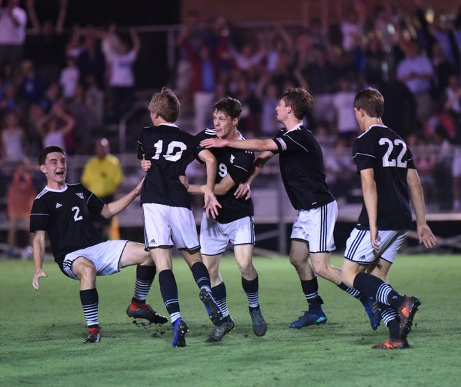 Westminster players celebrate a goal in Saturday night's GISA Class AAA state championship match against Holy Spirit Prep in Macon. The Wildcats won 2-1. [BRANCH CARTER/SPECIAL]