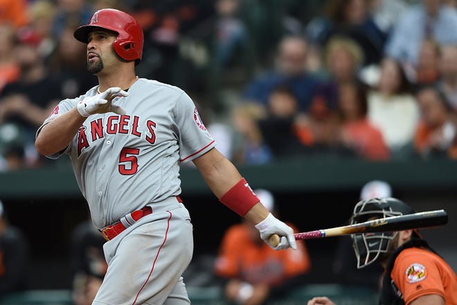 Los Angeles Angels' Albert Pujols follows through on a solo home run against the Baltimore Orioles in the fourth inning of the game on Saturday in Baltimore. [GAIL BURTON / ASSOCIATED PRESS]