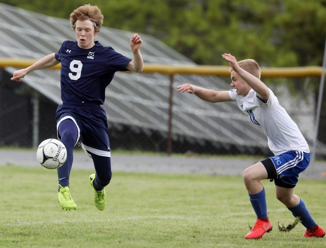 Notre Dame-West Burlington's Sam Brueck (9) stops the ball in front of Holy Trinity's Alex Mehmert in the first half of the SEI Superconference soccer tournament championship match. [John Lovretta/thehawkeye.com]