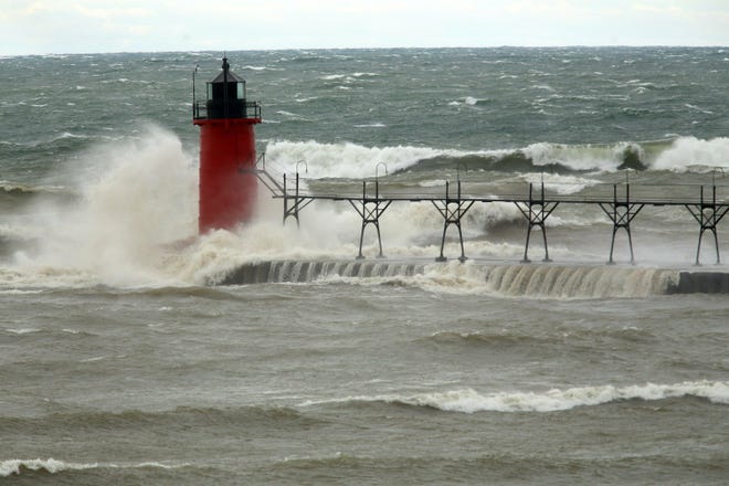 FILE--In this April 6, 2017 file photo, strong winds send huge waves at the Lake Michigan shoreline at South Haven, Michigan. (Mark Bugnaski/Kalamazoo Gazette via AP, File)