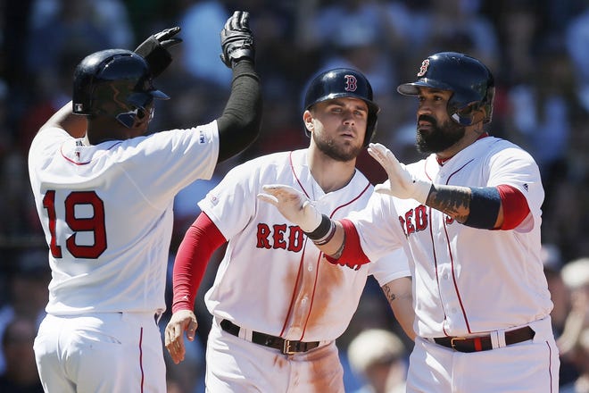 Sandy Leon (right) celebrates his three-run home run that drove in Michael Chavis (center) and Jackie Bradley Jr. during the third inning of a game against the Seattle Mariners in Boston on Saturday. [AP Photo/Michael Dwyer]