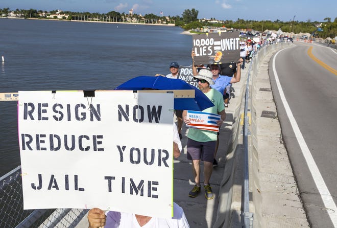 With Mar-a-Lago in the background, protesters demonstrating against Donald Trump cross the bridge over the Intracoastal Waterway as they return from Palm Beach Saturday afternoon, May 11, 2019. [LANNIS WATERS/palmbeachpost.com]