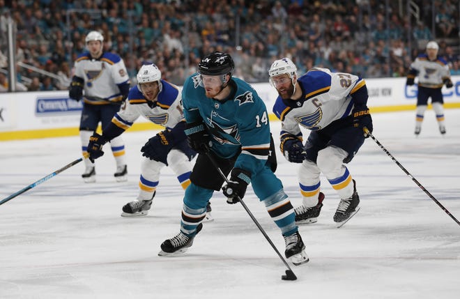 San Jose's Gustav Nyquist (14) moves the puck down the ice against the Blues' Brayden Schenn (10) and Alex Pietrangelo (27) in the first period of the Sharks' 6-3 win in Game 1 of their Stanley Cup semifinal playoff series Saturday night in San Jose, Calif. [JOSIE LEPE/THE ASSOCIATED PRESS]