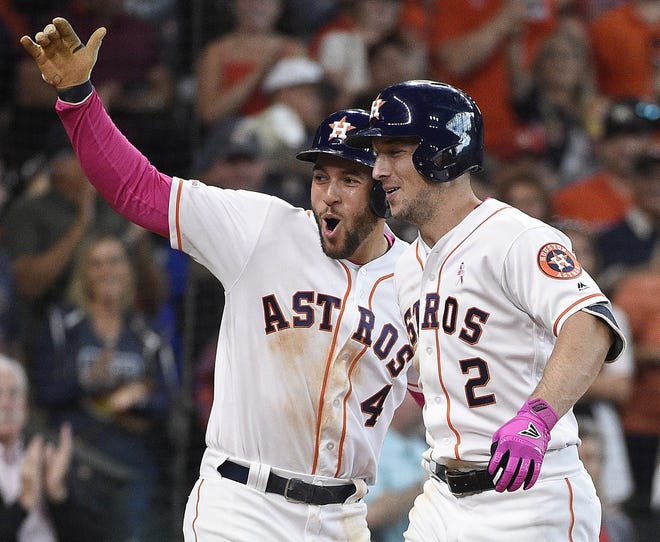 Houston's Alex Bregman, right, celebrates his three-run home run in the fifth inning with George Springer on Sunday. It was Bregman's second homer of the game, and Springer had two as well. [Eric Christian Smith/The Associated Press]