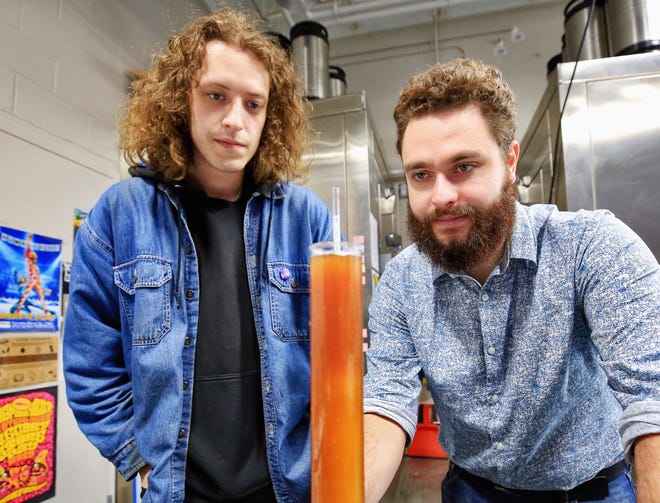 University of New Hampshire students Lucas Carroll, left, and Jeffrey Baron measure the amount of dissolved sugars in a brew they created along with other students depicting a piece os Seacoast history. The students brewed a beer they think would have been drank on Smuttynose Island in the 1600s based on their research.

[Ioanna Raptis/Seacoastonline]