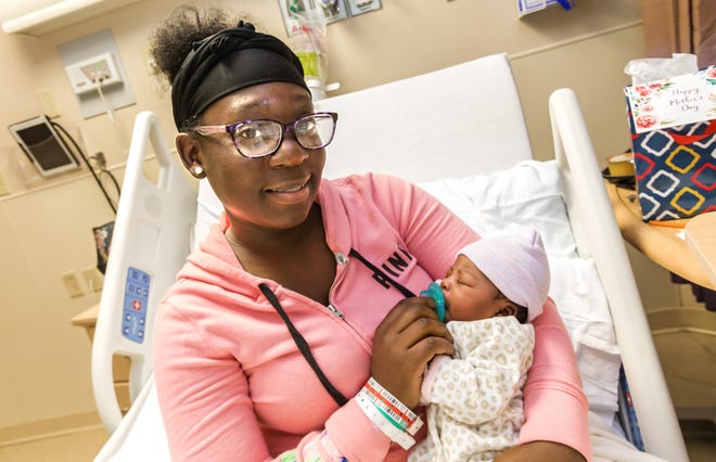 Adline Boucicaut sits with her daughter, Sanaii, to whom she gave birth shortly after midnight on Mother's Day, Sunday, May 12, 2019, at West Boca Medical Center. [LANNIS WATERS/palmbeachpost.com]