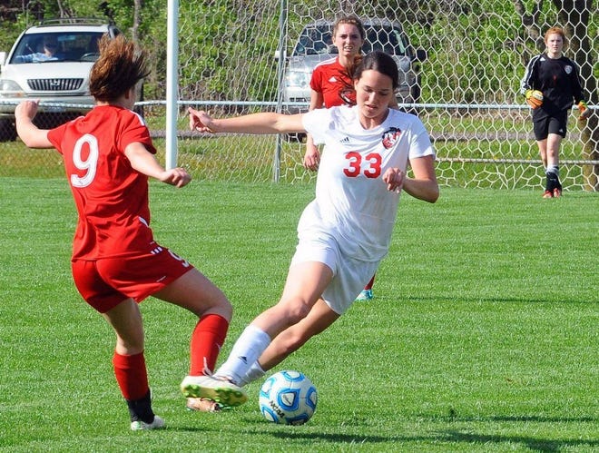 Pekin girls soccer player Tyranie Cox moves around a player during a Mid-Illini Conference game last season. [GATEHOUSE MEDIA ILLINOIS ARCHIVES]