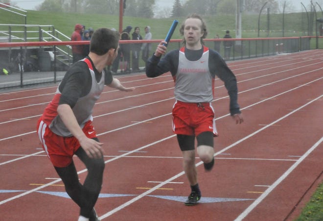 Canandaigua senior Iain Stain hands the baton to teammate Dan DiSalvo during the 4x100 boys relay on Monday against Webster Thomas. [Bob Chavez/Messenger Post Media]