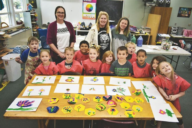 At Dunsmuir Elementary School Watershed Art Program, Kindergarten and 1st graders stand around a table of their art work of painted flowers in Rami White's class that will be put together in a mural and on display at the Siskiyou Arts Museum starting May 11.