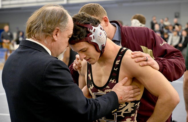 Algonquin's Andrew Goddard is consoled by coaches James Gray (left) and Brian Kramer after falling to Springfield Central's Cesar Alvan in the 160-pound championship match at All-States at St. John's Prep in Danvers this past wrestling season. [Daily News and Wicked Local Staff File Photo/Ken McGagh]
