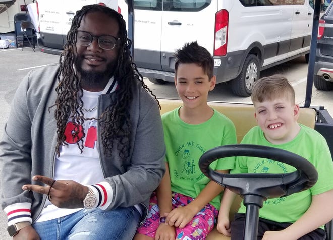 Rapper T-Pain visits with fourth-graders Gunnar Franchione and Owen Sirmons backstage while shooting an episode of his TV show, "T-Pain's School of Business," at Lehman High School in Kyle May 13. [Contributed by Rebecca Franchione]