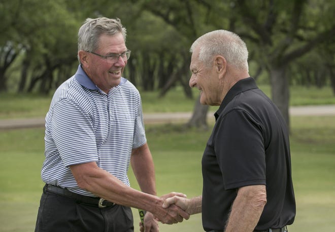 Mark Sutton, left, and Tom Leonardis shake hands after hitting some balls at the Austin Golf Club in Spicewood. The two met at Austin Speech Labs after they both had a stroke, and they formed a friendship around their love of golf. [JAY JANNER/AMERICAN-STATESMAN]