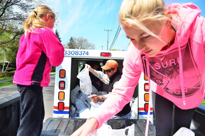 Folks will load up mail trucks during Holland's annual Postal Food Drive Saturday, May 18. [Sentinel file]