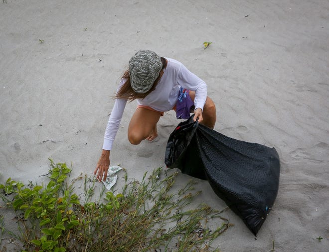 Holistic health coach and wellness educator Amy Elise participates in a Turtle Tuesday beach cleanup event at Midtown Beach in 2016. 'There's an inextricable link between people and the planet,' Elise said that day. 'Everything that's harming the planet is harming us. If we can just be healthy, everything else will take care of itself.' [Damon Higgins/palmbeachdailynews.com file photo]