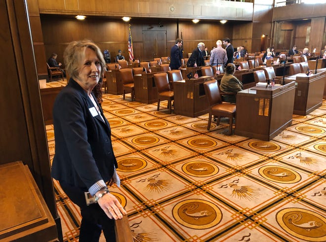 Sergeant at Arms Leta Edwards stands in the foreground on Friday, May 10 as Democratic senators talk among themselves on the Senate floor on after the Senate failed to reach a quorum for the fourth straight day because of a Republican boycott in Salem. Republican senators began their walkout on Tuesday, May 7, 2019, to protest an education-funding bill that imposes a tax on some businesses. (AP Photo/Andrew Selsky)
