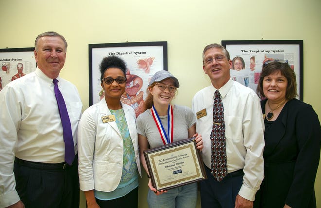 Craven CC student Christina ìRuî Fletcher receives a 2019 Academic Excellence Award. The North Carolina Community College System recognized one student from each of the stateís 58 community colleges. Pictured left to right are Jim Millard, Craven CC vice president for administration; Zomar Peter, Craven CC dean of enrollment management; Ru Fletcher; Dr. Ray Staats, Craven CC president; and Dr. Kathleen Gallman, Craven CC vice president for instruction. [CONTRIBUTED PHOTO]