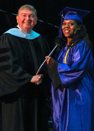 Tyeshia Bryant, right, receives her associateþÄôs degree in Medical Office Administration from PCC President Dr. Jim Ross. She is the college's 2019 Academic Excellence Award recipient and Student of the Year. [CONTRIBUTED PHOTO]