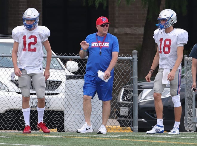 Chap quarterbacks Drew Willoughby (12) and Cade Klubnik (18) step on to the field with coach Todd Dodge during spring football practice at Westlake High School on May 7. [PAUL BRICK/FOR STATESMAN]