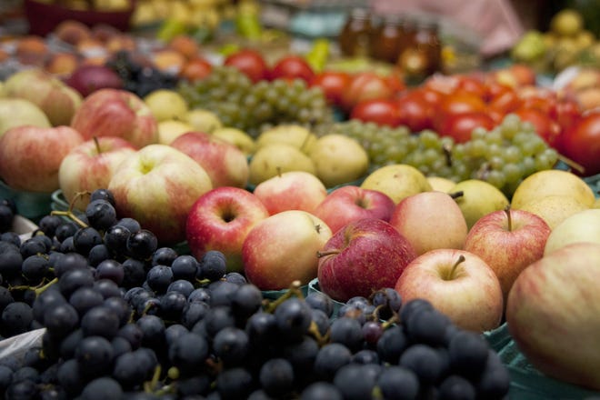 Produce is displayed for sale at a farmers market in Kalamazoo, Mich. A study released on Wednesday suggests that trimming dietary fat and eating more fruits and vegetables may lower a woman's risk of dying of breast cancer. [Katie Alaimo/Kalamazoo Gazette via AP]