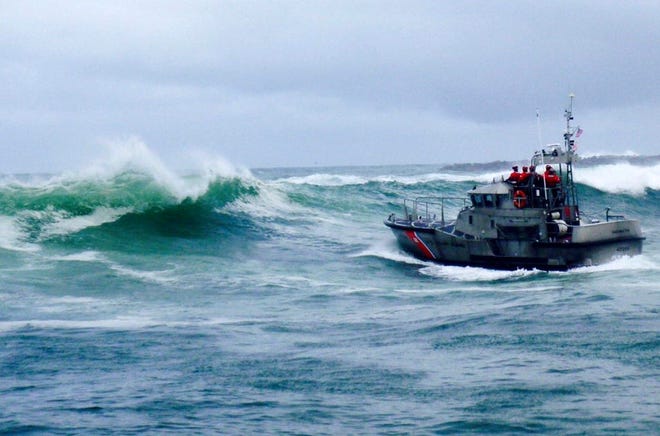 FILE - In this Tuesday, Jan. 8, 2019 file photo, provided by the U.S. Coast Guard, a U.S. Coast Guard boat crew responds to three fishermen in the water after the commercial fishing vessel Mary B II capsized while crossing Yaquina Bay Bar off the coast of Newport, Ore. Three people were killed. A crew member of a doomed crabbing vessel that sank off the Oregon coast texted with his wife until the final moments before he was tossed overboard as the U.S. Coast Guard tried to reach the boat in 20-foot waves. Josh Porter's wife, Denise Porter, gave tearful testimony Wednesday, May 15, 2019 about those texts and a desperate phone call from her husband on the third day of a Coast Guard hearing into the wreck (U.S. Coast Guard via AP, File)