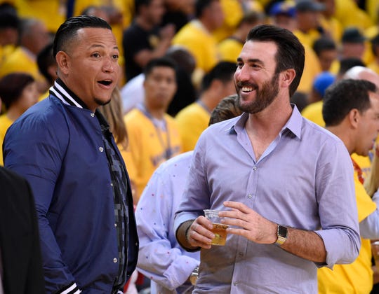 Miguel Cabrera, left, and Justin Verlander laugh at an NBA playoff game at Oracle Arena on May 27, 2015 in Oakland.
