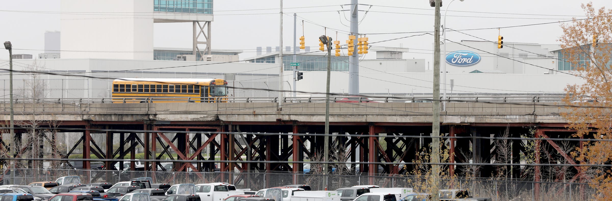 A school bus and other vehicles cross over the Miller Road Bridge in Dearborn on Thursday, April 2, 2019. The bridge has hundreds of temporary supports.