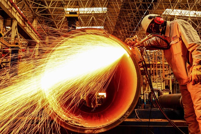 A worker cuts an oil pipe at a factory in Qingdao in China's eastern Shandong province on February 28, 2019. - China's manufacturing activity shrunk for a third straight month in February, sinking to its worst performance in three years as the economy slows and the US trade war bites, official data showed on February 28. (Photo by STR / AFP) / China OUTSTR/AFP/Getty Images