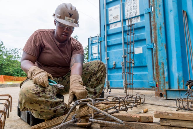 Steelworker 3rd Class Melessa Smoke, from Millbrook ties together rebar cages during the construction of the new Nan U Medical Dispensary in Pohnpei, Federated States of Micronesia on May 7.