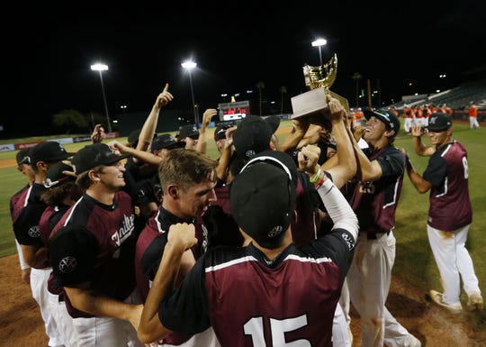 Hamilton players celebrate after beating Corona del Sol 8-1 to win the 6A State Baseball Championship in Tempe, Ariz. May 15, 2019.