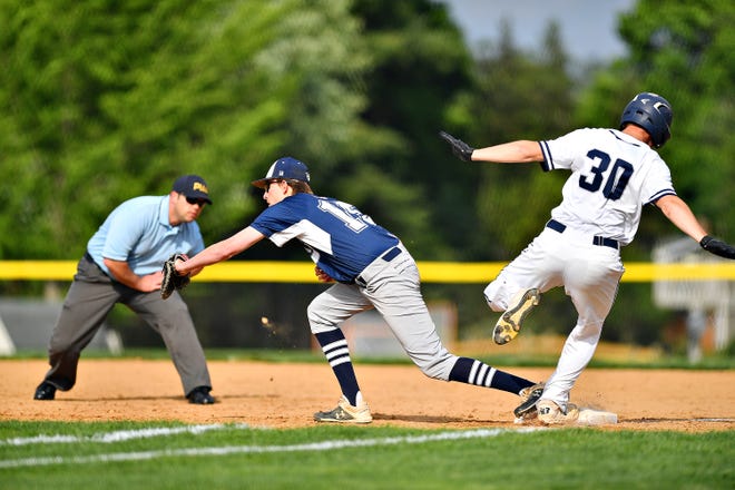 Dallastown's Peyton Fox, left, catches the ball at first to out West York's Seth Eyler during baseball semifinal action at Spring Grove Area High School in Jackson Township, Wednesday, May 15, 2019. Dallastown would win the game 12-0. Dawn J. Sagert photo