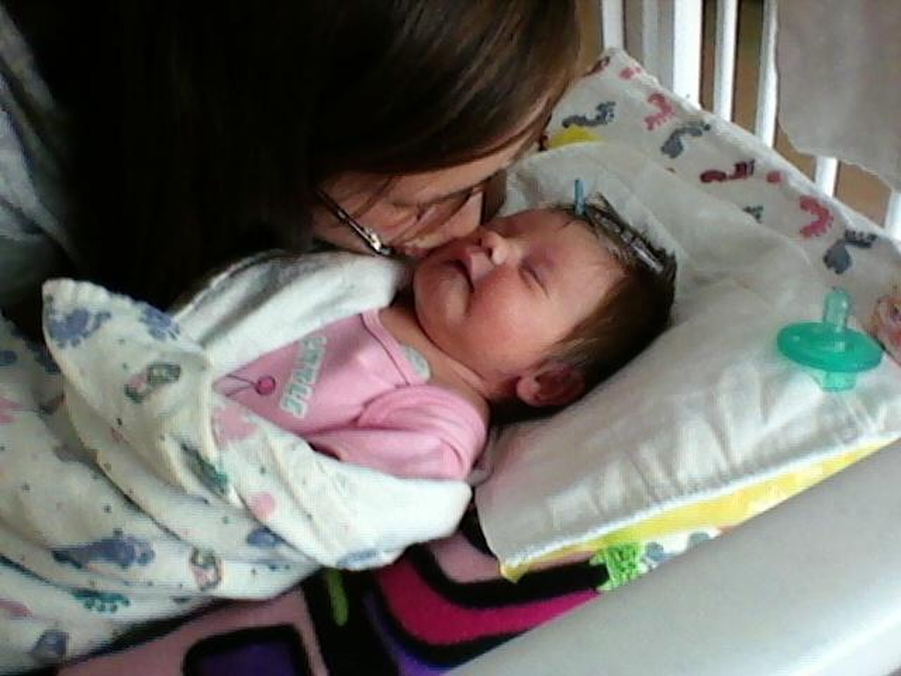 Emilee Strezinski kisses her daughter Amelia.