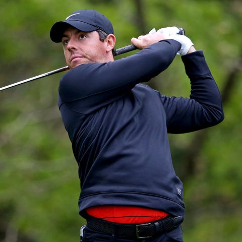 Rory McIlroy plays his shot from the eighth tee...