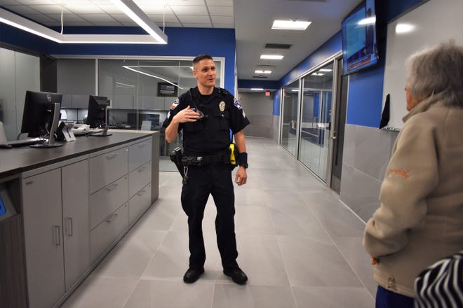 Lakeway Police Sergeant Eric Barto leads a group of visitors through the patrol side of the city's new police station May 11. The Lakeway community was invited to a ribbon cutting ceremony and tour of the new facility. [PHOTO BY LESLEE BASSMAN]