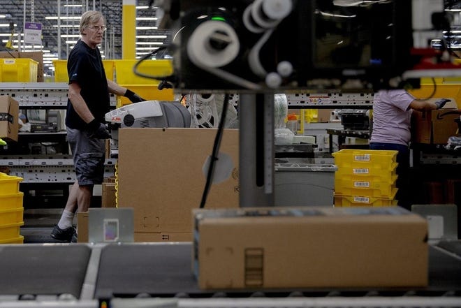 Amazon is gearing up for one-day delivery by investing millions to improve its network of warehouses. [NICK WAGNER/AUSTIN AMERICAN-STATESMAN]
