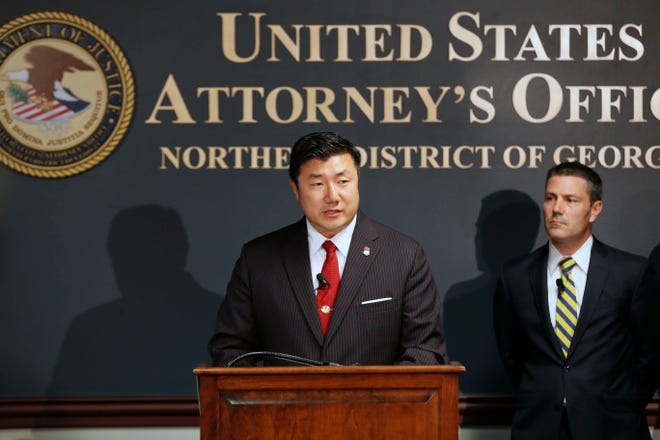 U.S. Attorney Byung J. "BJay" Pak, at the podium next to Chris Hacker, Special Agent in Charge of FBI Atlanta, announces that Georgia Insurance Commissioner Jim C. Beck has been indicted by a federal grand jury on charges of wire fraud, mail fraud and money laundering, Tuesday, May 14, 2019 in Atlanta. (Bob Andres/Atlanta Journal-Constitution via AP)