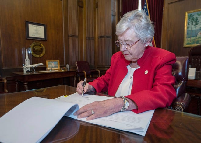 This photograph released by the state shows Alabama Gov. Kay Ivey signing a bill that virtually outlaws abortion in the state on Wednesday, May 15, 2019, in Montgomery, Ala. Republicans who support the measure hope challenges to the law will be used by conservative justices on the U.S. Supreme Court to overturn the Roe v. Wade decision which legalized abortion nationwide. (Hal Yeager/Alabama Governor's Office via AP)