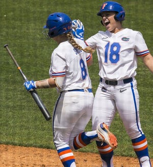 Florida team leader Amanda Lorenz (18) gives teammate Hannah Sipos a high-five during a game earlier this season at Katie Seashole Pressly Stadium. The Gators enter NCAA tourney play today off the high of winning back-to-back SEC tournament titles. [Cyndi Chambers/Correspondent]