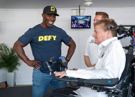 Former Denver Bronco and pro football Hall-of-famer Terrell Davis talks with IndyCar team owner Sam Schmidt at the Indianapolis Motor Speedway on Thursday, May 16, 2019. Davis and DEFY CBD-based performance drink have teamed up and are a sponsor Arrow Schmidt Peterson Motorsports.