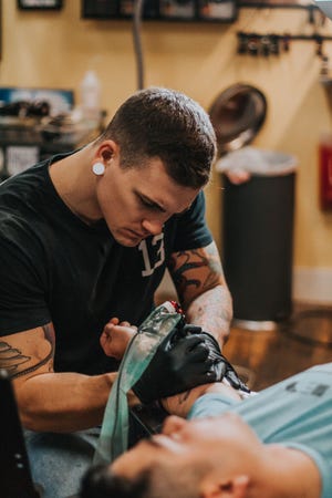 Cam Pohl, a Grand Ledge native, is a tattoo artist who worked at Fish Ladder Tattoo Company in Lansing. He's a contestant on the reality TV show "Ink Master."