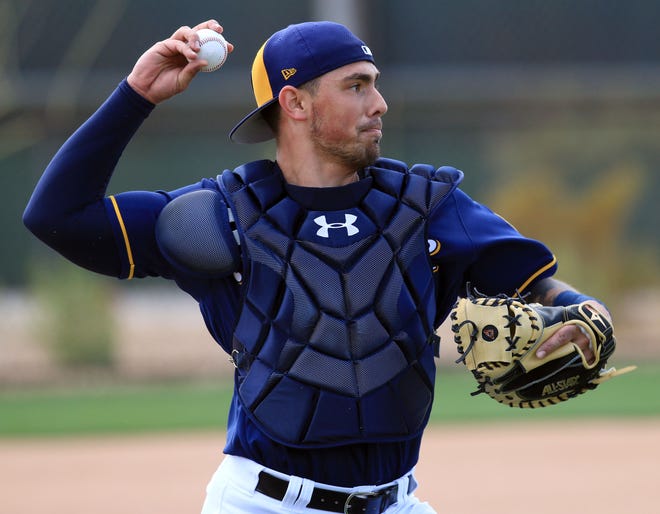 Catcher Jacob Nottingham was among five players the Brewers optioned to the minors Friday to reduce their spring training roster.
