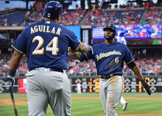 Brewers centerback Lorenzo Cain celebrates with first baseman Jesus Aguilar after scoring a goal in the third inning on Wednesday night.