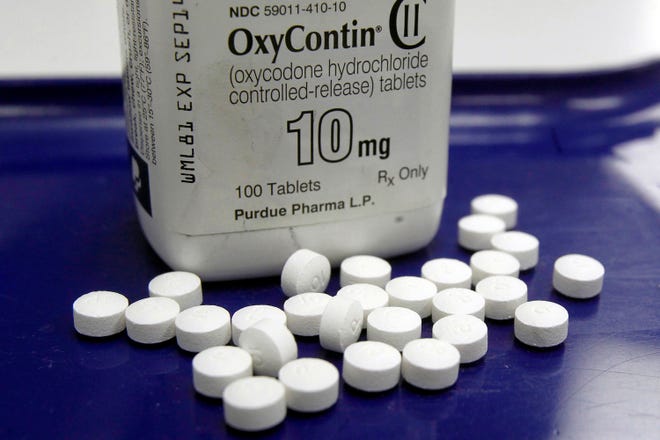 This Feb. 19, 2013, file photo shows OxyContin pills arranged for a photo at a pharmacy, in Montpelier, Vt.