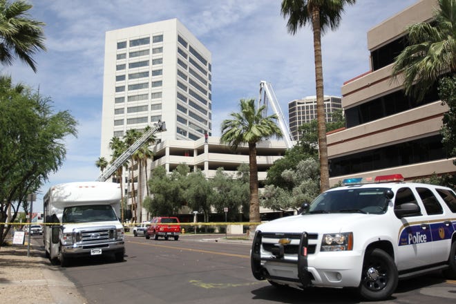 Phoenix police and fire officials are negotiating with an "adult male in crisis" who is standing on a six-story parking garage.