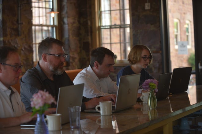 From left, MarketBeat's Ryan Quam, Will Bushee, Matt Paulson and Rebecca McKeever work on laptops at Queen City Bakery in Sioux Falls.  MarketBeat, an online tool for individual investors, forecasts $9 million in revenue in 2019, nearly triple of what the company brought in a couple of years ago.