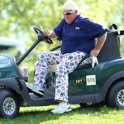 John Daly gets out of his cart on the third hole...