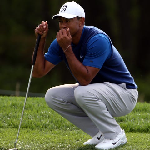 Tiger Woods lines up his putt on the 10th green.